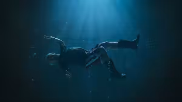 Digger Rockwell (Tom Cruise) floating underwater in shafts of light