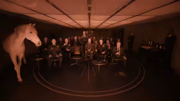 A group gathers around a conference table as a horse enters the room