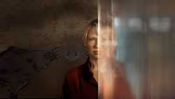 A woman peers through a glass partition, her face partly hidden behind its frame