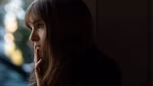 Elizabeth (Natalie Portman) holds her hand near her mouth while looking sideways