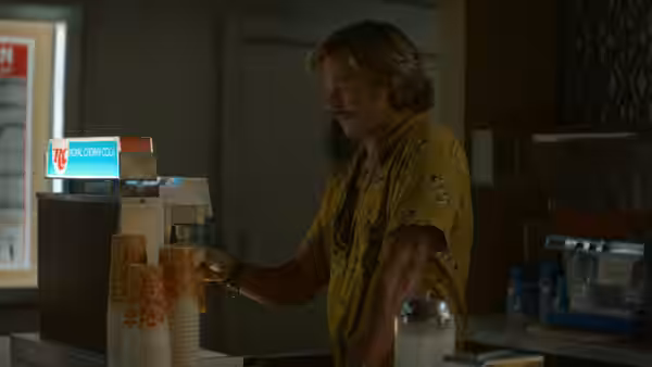Cliff Booth (Brad Pitt) dispensing soda from a fountain machine