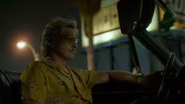Cliff Booth (Brad Pitt) at the wheel of a car at night