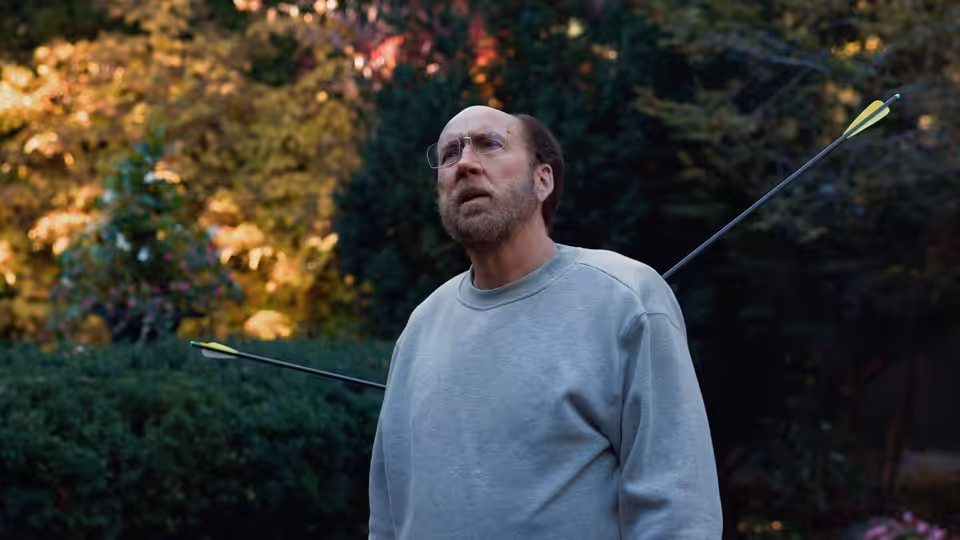 Paul Matthews (Nicolas Cage) standing outdoors with arrows stuck in his back
