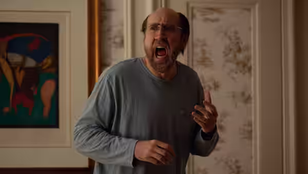 Paul Matthews (Nicolas Cage) gesturing with mouth open in a bedroom