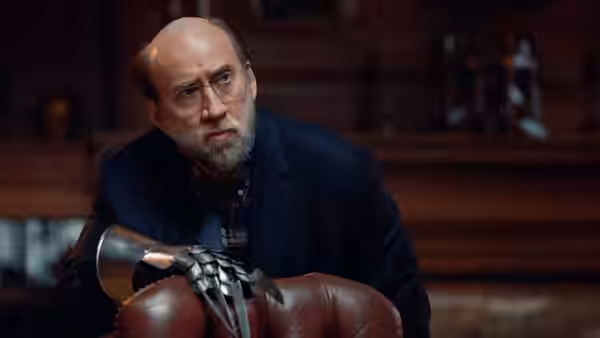 Paul Matthews (Nicolas Cage) seated with a metallic claw prosthetic on his hand