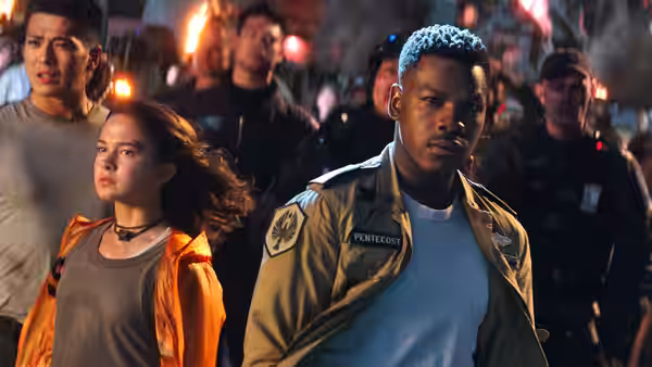 Jake Pentecost (John Boyega) stands with a woman in a nighttime crowd