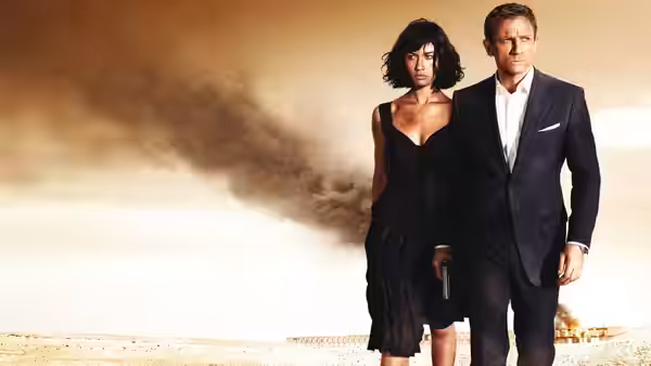 James Bond (Daniel Craig) and Camille (Olga Kurylenko) standing in smoky desert