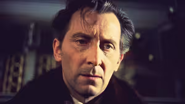 Arthur Holmwood (Michael Gough) stares ahead in a dim room