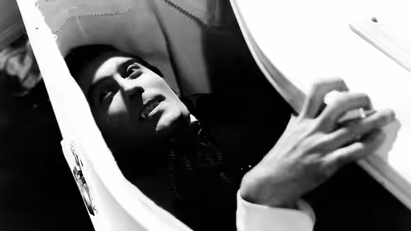 Count Dracula (Christopher Lee) lies in a coffin as someone lifts its lid