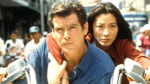 James Bond (Pierce Brosnan) and Wai Lin (Michelle Yeoh) riding a motorcycle in a busy street