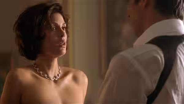Paris Carver (Teri Hatcher) talking to James Bond in an elegant room