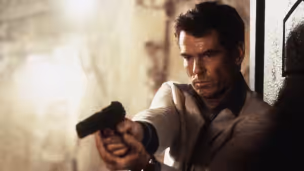 Pierce Brosnan as James Bond aims a handgun while taking cover