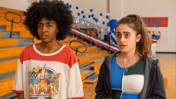 Josie (Ayo Edebiri) and PJ (Rachel Sennott) standing in an empty gymnasium