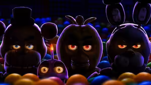 Animatronic characters emerging from a colorful ball pit with glowing eyes