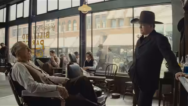 William Hale (Robert De Niro) seated in a wheelchair facing a standing man in a cafe