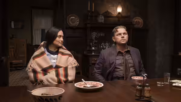 Mollie Burkhart (Lily Gladstone) and Tom White (Jesse Plemons) at a dining table