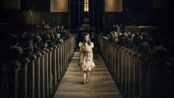 Young girl in stained dress walks down aisle of crowded church
