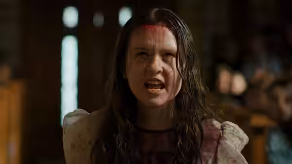 Bloodied young woman with torn face shouts angrily inside church
