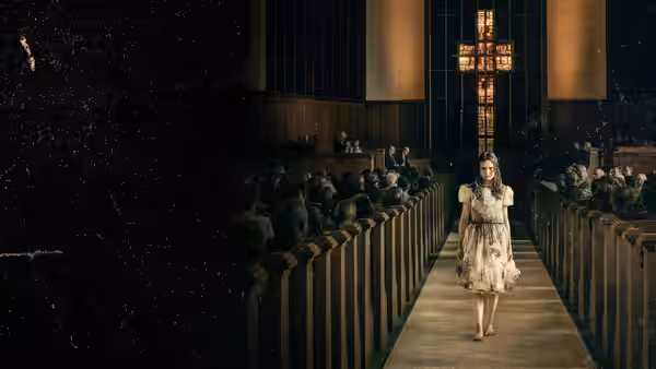 Young girl in white dress walks toward altar in large church