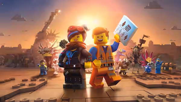 Wyldstyle and Emmet holding a book in a ruined city at sunset