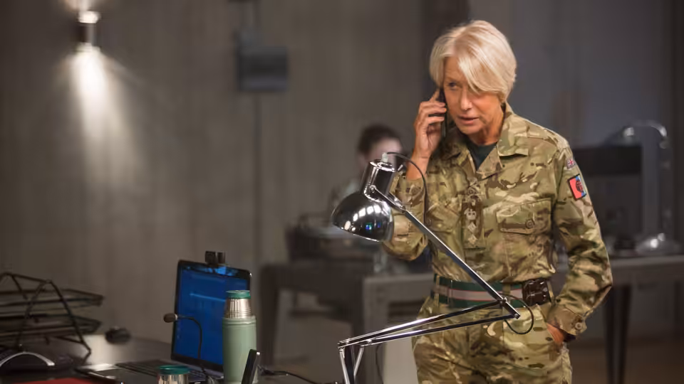 Colonel Katherine Powell (Helen Mirren) takes a phone call in a military operations room