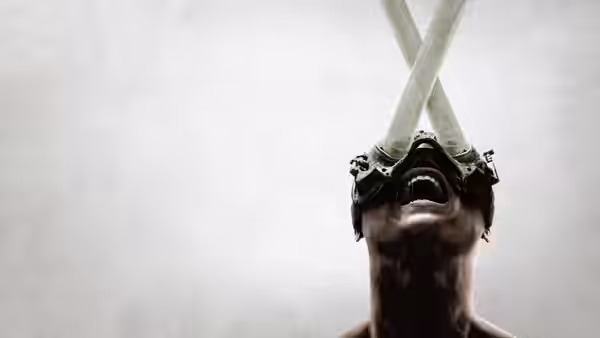 a person with crossed tubes attached to their head looking upward