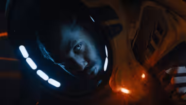 Joshua (John David Washington) inside helmet looking forward intently