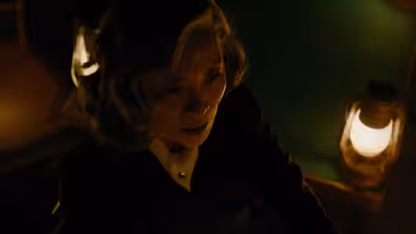 Woman with graying hair looking concerned in a dimly lit room