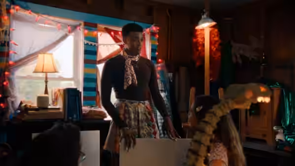 adult in a skirt speaking to a child in a colorful room