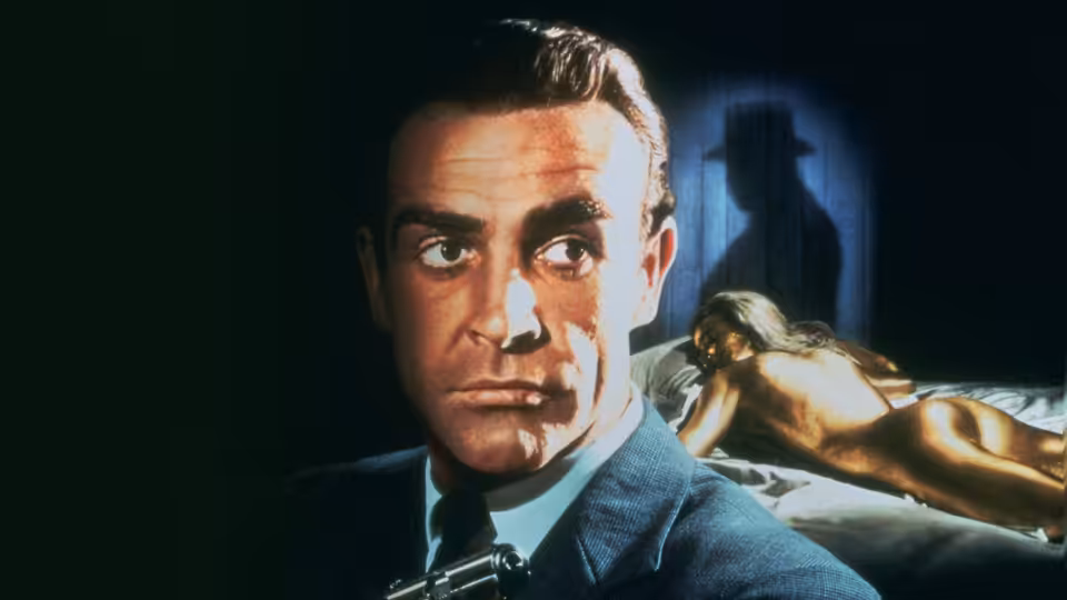 James Bond (Sean Connery) stares ahead with a gold-painted woman behind him