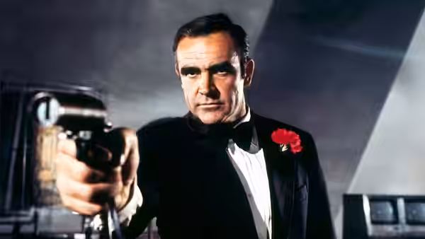 James Bond (Sean Connery) aiming a pistol while in a tuxedo