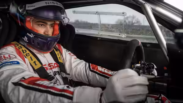 Jann Mardenborough (Archie Madekwe) gripping the wheel inside his race car