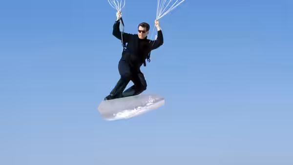 James Bond (Pierce Brosnan) parasurfing on a board beneath a parachute
