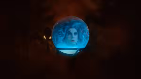 Madame Leota (Jamie Lee Curtis) floating inside a glowing crystal ball