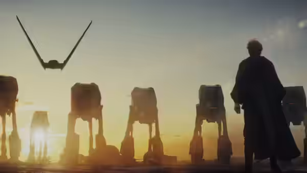 Luke Skywalker (Mark Hamill) stands before AT-AT walkers at sunset with a ship overhead