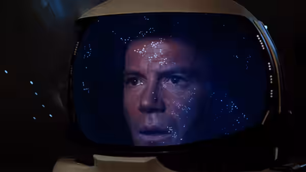 Admiral James T. Kirk inside a spacesuit helmet covered in water droplets