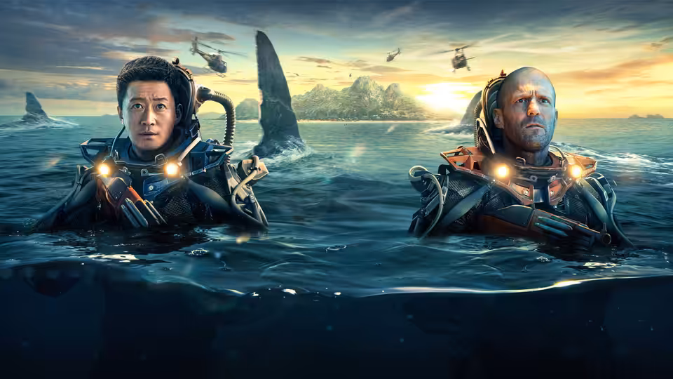Two divers in illuminated suits float in the ocean near giant sharks and helicopters
