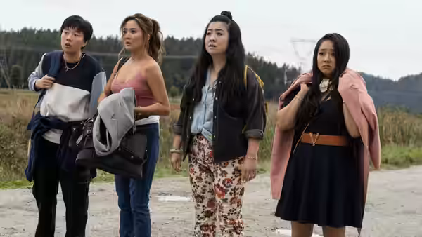 Four women standing together on a rural dirt road looking ahead