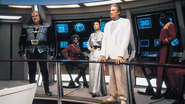 Uhura (Nichelle Nichols) among officers and aliens in a starship control room