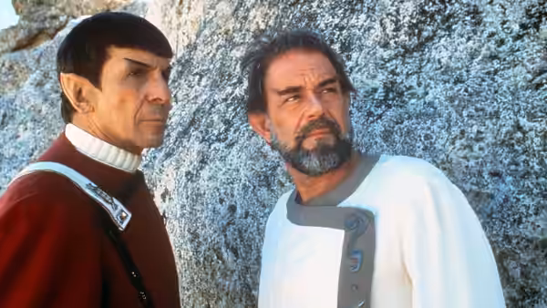 Spock (Leonard Nimoy) and McCoy (DeForest Kelley) standing by a rocky cliff