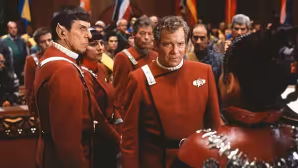 Spock (Leonard Nimoy) and Kirk (William Shatner) in red uniforms facing forward
