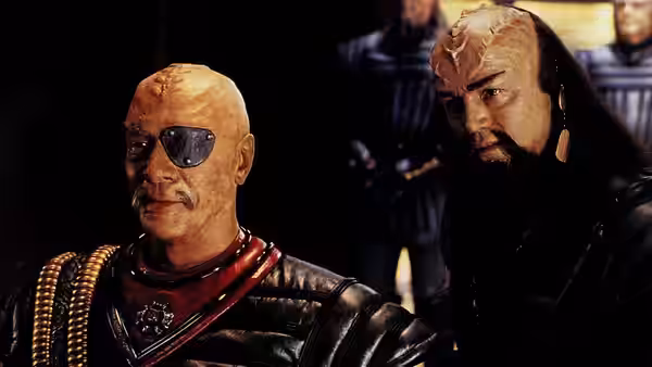 Two Klingon officers in dark leather armor looking toward the right