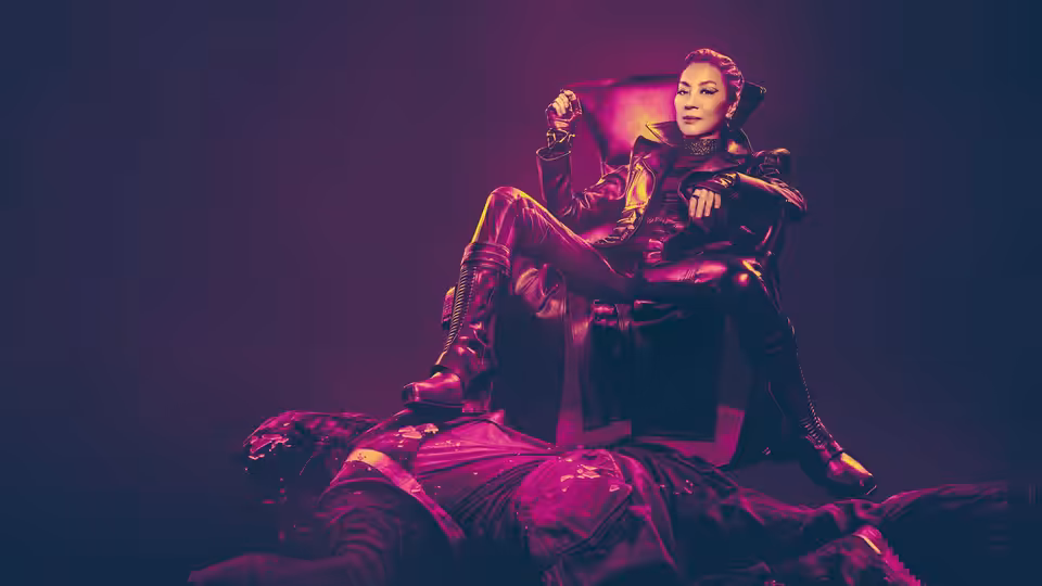 Philippa Georgiou (Michelle Yeoh) seated on a throne above a fallen figure