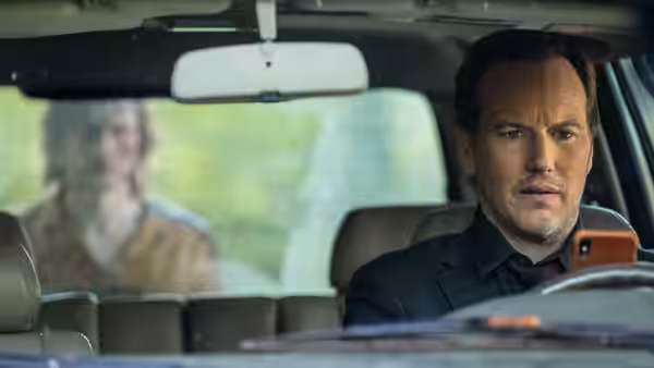 Josh Lambert (Patrick Wilson) sits in a car looking at a figure outside