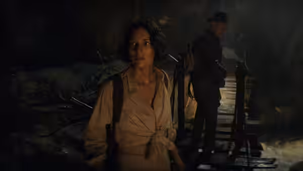 Helena (Phoebe Waller-Bridge) and Indiana Jones (Harrison Ford) on a bridge inside a cave