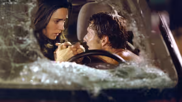Betty Ross and Bruce Banner clasp hands inside a submerged vehicle