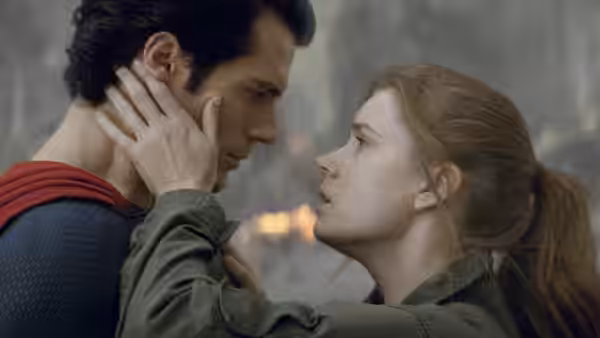 Lois Lane (Amy Adams) cups Clark Kent’s (Henry Cavill) face amid destruction