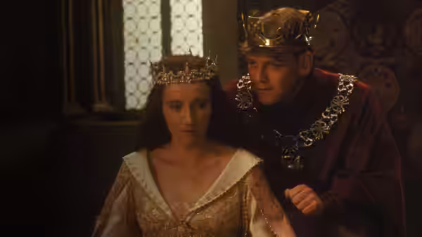 Henry V (Kenneth Branagh) leans beside Katherine (Emma Thompson) in a royal chamber
