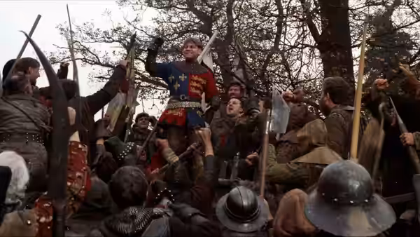 Henry V (Kenneth Branagh) raises his sword above cheering soldiers on the battlefield