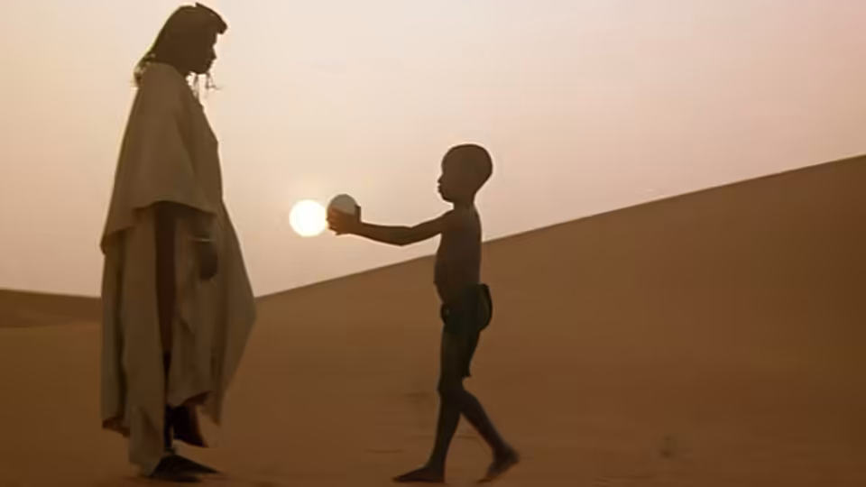 A cloaked adult faces a child holding the setting sun over the desert